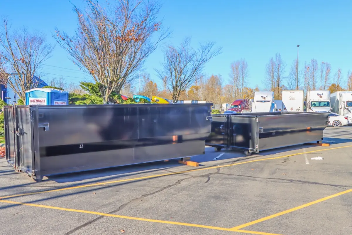 Professional dumpster rental service with roll-off container on residential driveway in Lacy-Lakeview